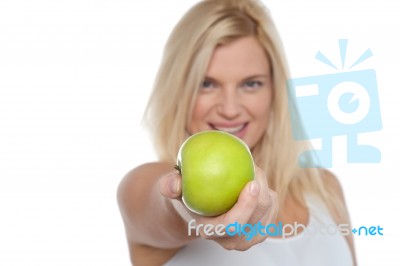 Glamorous Blonde Offering You Juicy Green Apple Stock Photo