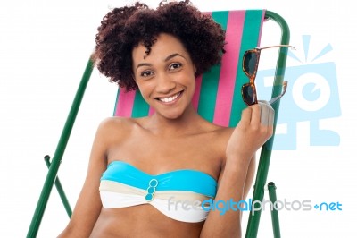 Glamorous Woman In Lingerie Relaxing On A Deckchair Stock Photo