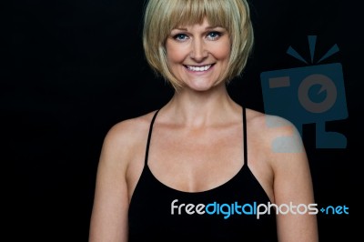 Glamorous Woman In Sleeveless Black Spaghetti Top Stock Photo