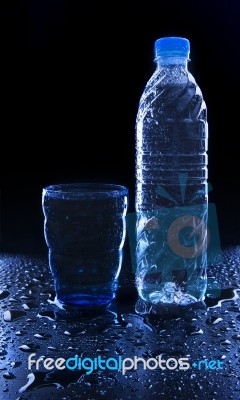 Glass And Bottle On Freshness Drinking Water On Wet Floor With C… Stock Photo