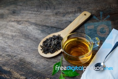 Glass Cup Of Tea And Spoons With Dried Leaves Tea Stock Photo