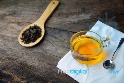 Glass Cup Of Tea And Spoons With Dried Leaves Tea And Green Leav… Stock Photo