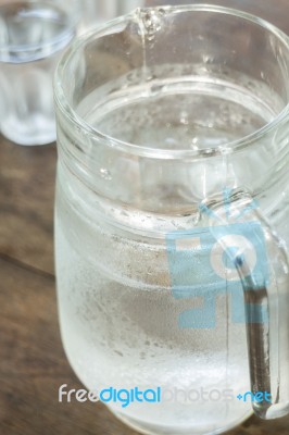 Glass Jar Of Cold Water On Wooden Table Stock Photo