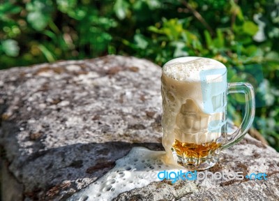 Glass Mug With Beer Standing On The Big Stone Stock Photo