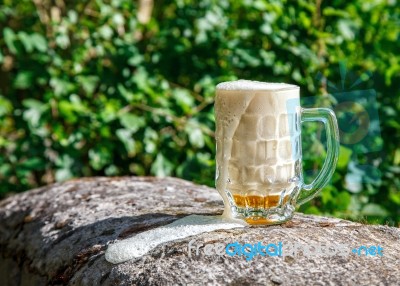 Glass Mug With Beer Standing On The Big Stone Stock Photo