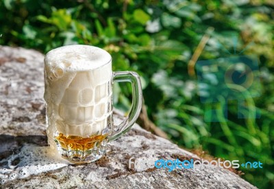 Glass Mug With Beer Standing On The Big Stone Stock Photo