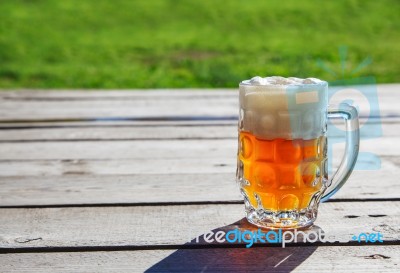 Glass Mug With Beer Standing On The Table Outdoor Stock Photo