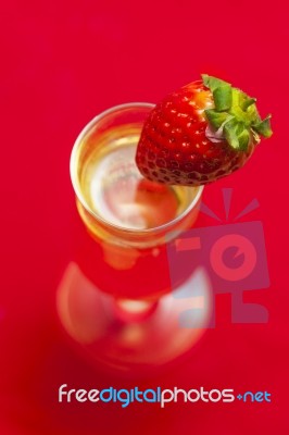 Glass Of Champagne With A Strawberry Stock Photo