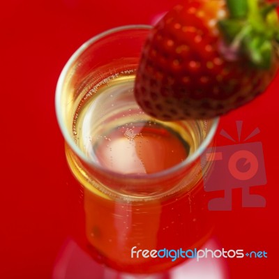 Glass Of Champagne With A Strawberry Stock Photo