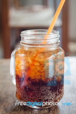 Glass Of Cola With Ice On Wooden Table Stock Photo