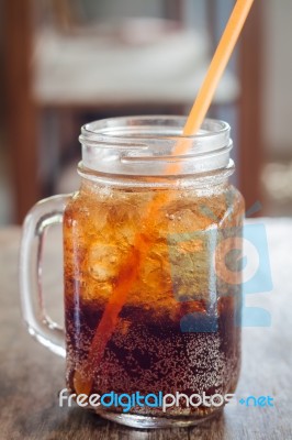 Glass Of Cola With Ice On Wooden Table Stock Photo