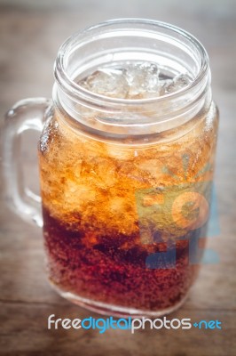 Glass Of Cola With Ice On Wooden Table Stock Photo