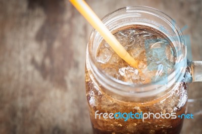 Glass Of Cola With Ice On Wooden Table Stock Photo