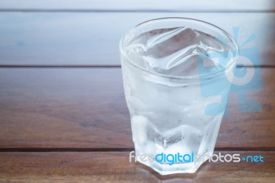 Glass Of Cold Water On Wooden Table Stock Photo