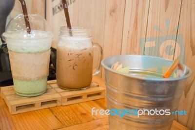 Glass Of Iced Drink On Wooden Table Stock Photo