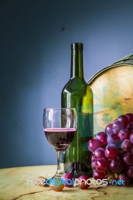 Glass Of Red Wine On A Wooden Stock Photo