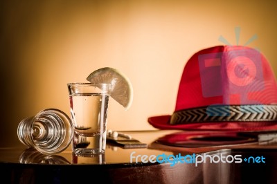 Glass Of Vodka And Classical Guitar With Red Hat Stock Photo