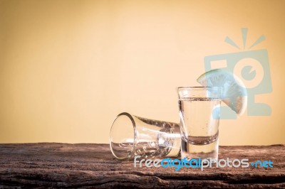 Glass Of Vodka On The Old Wooden Table Stock Photo