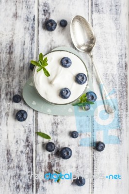 Glass Of Yogurt With Fresh Blueberries Stock Photo