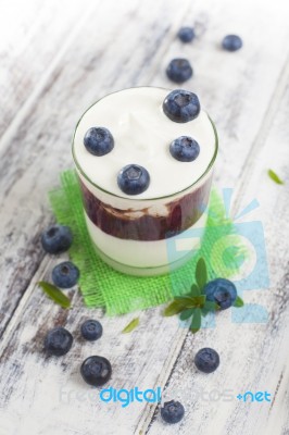 Glass Of Yogurt With Fresh Blueberries Stock Photo