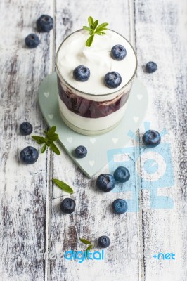 Glass Of Yogurt With Fresh Blueberries Stock Photo