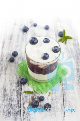 Glass Of Yogurt With Fresh Blueberries Stock Photo