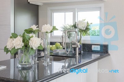 Glass Vase Of Flower On Black Granite Counter Stock Photo