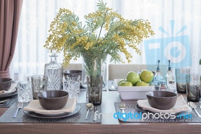 Glass Vase Of Flower On Dinning Table With Table Set Stock Photo