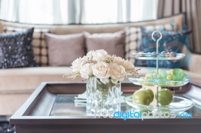 Glass Vase Of Flower On Wooden Table In Living Room Stock Photo