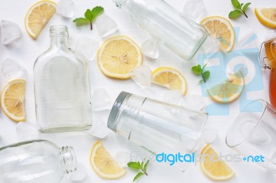 Glasses And Bottle For Drinks With Lemon Slices, Mint And Honey Stock Photo