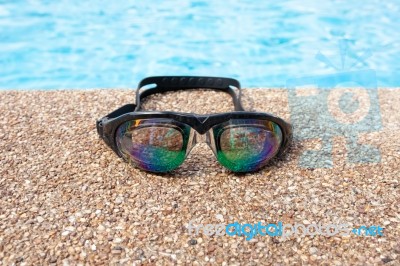 Glasses For Swimming On A Cement Floor With Small Stone Near Swi… Stock Photo