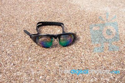 Glasses For Swimming On A Cement Floor With Small Stone Near Swi… Stock Photo