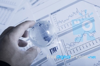 Globe With Chart Papers Stock Photo