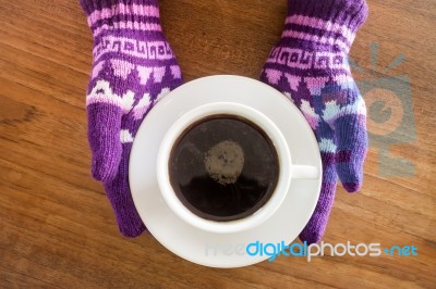 Gloved Hands Holding Cup Of Coffee Stock Photo