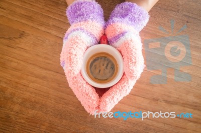 Gloved Hands Holding Cup Of Coffee Stock Photo