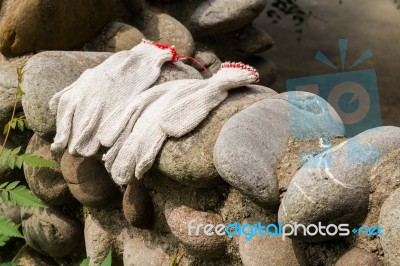 Gloves Workers Were Left On A Stone Wall Stock Photo