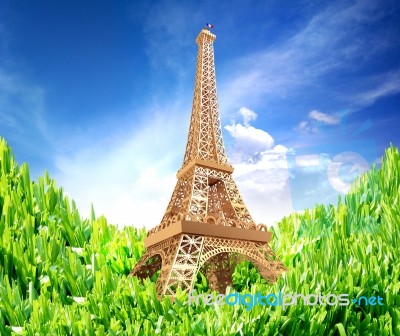 Gold Eiffel Tower On Green Grass. With Blue Sky Stock Photo