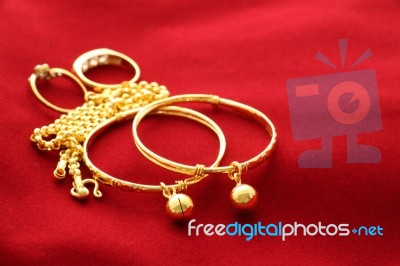 Gold Jewelry Ornament On A Red Floor Stock Photo