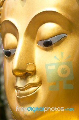 Golden Buddhist Statue Face Stock Photo