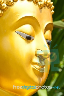 Golden Buddhist Statue Face Stock Photo