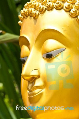 Golden Buddhist Statue Face Stock Photo