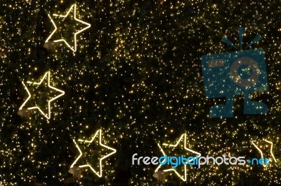 Golden Decoration Light In Shape Of Star On Christmas Pine Tree Stock Photo