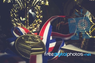 Golden Metal With Ribbon Red White And Blue Around It Laying In Stock Photo