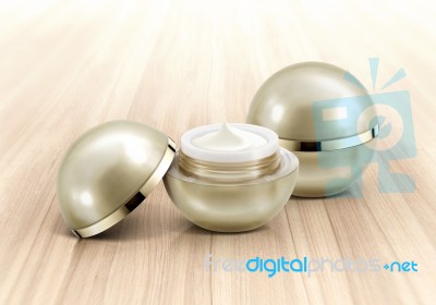 Golden Sphere Cosmetic Jar On Wood Background Stock Photo