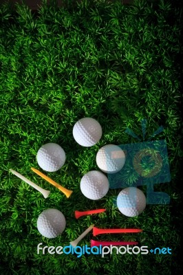 Golf And Tee On Green Grass Stock Photo