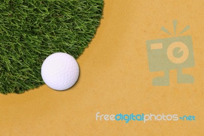 Golf Ball Edge Of Grass Field And Sand Stock Photo