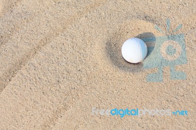 Golf Ball In Sand Bunker Stock Photo