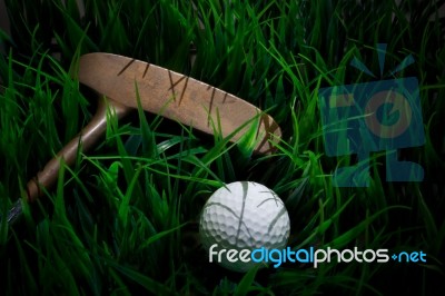 Golf Ball On Green Grass And Putter Stock Photo