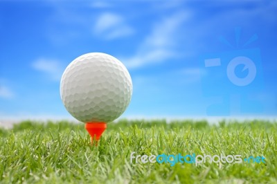 Golf Ball Plastic Tee With Blur Blue Sky Stock Photo