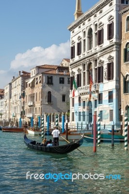 Gondolier Ferrying People In Venice Stock Photo